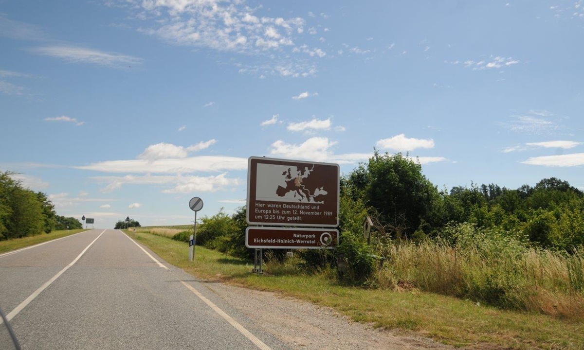 Hinweisschild am Strassenrand "Hier waren Deutschland und Europa bis zum 12. November 1989 um 12:25 Uhr geteilt